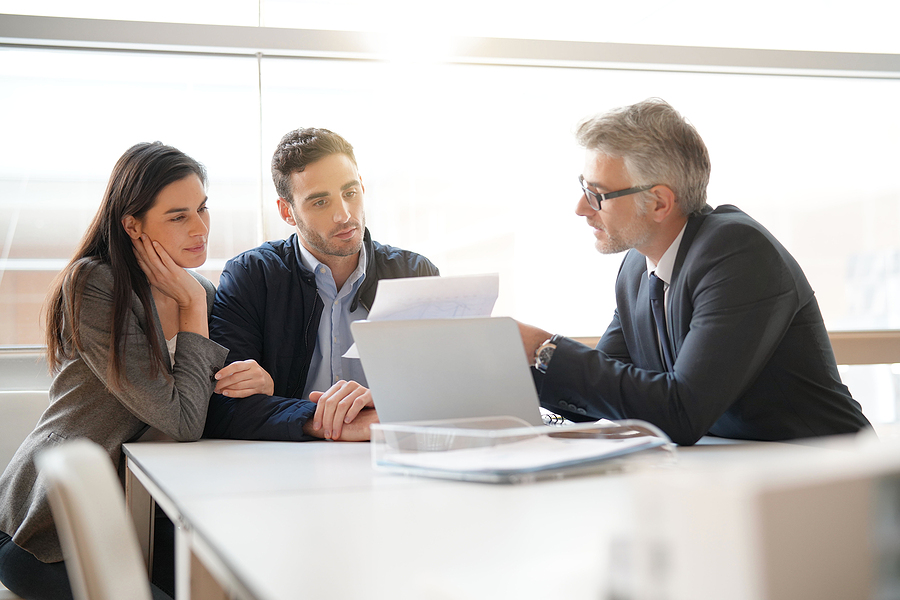 estate lawyer discussing about liquid assets with couple